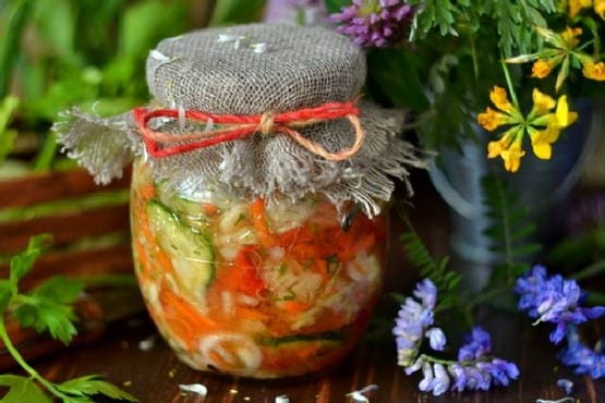 Salad with cabbage, cucumbers, tomatoes, peppers, carrots and onions for the winter