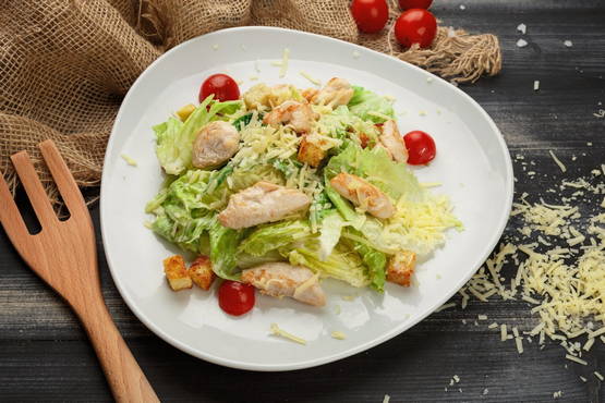 Caesar salad with chicken and tomatoes