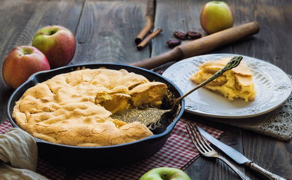 Charlotte with apples in a pan