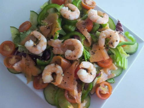 Caesar salad with shrimps and salmon