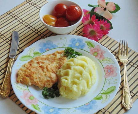 Chicken chops in egg in a frying pan