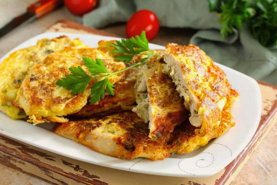 Chicken chops in potato batter in a pan