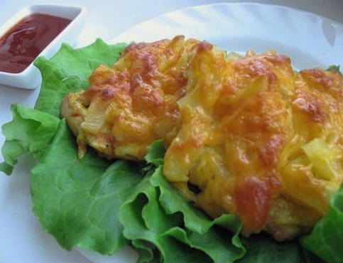 Chicken chops with pineapple and cheese in the oven