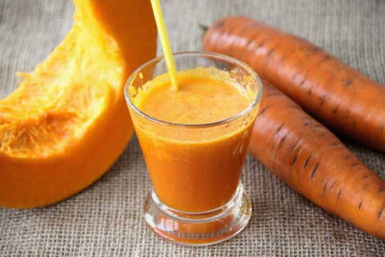 Pumpkin and carrot juice in a juicer for the winter