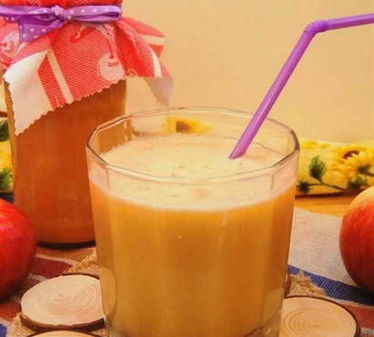 Pumpkin and apple juice in a juicer