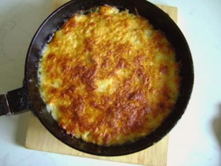 Julienne with chicken and mushrooms, cheese and cream in a pan