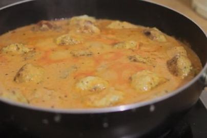 Minced chicken hedgehogs with rice and gravy in a pan