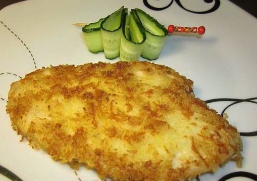 Chicken schnitzel with cheese in a pan