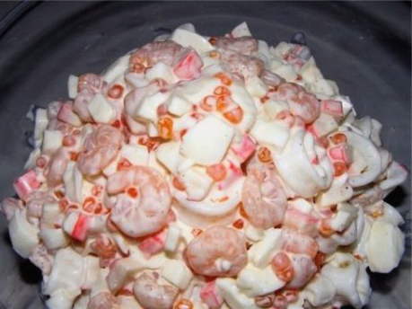 Salad with squid, shrimps, crab sticks and eggs