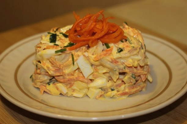 Salad with squid, egg, onion and carrot