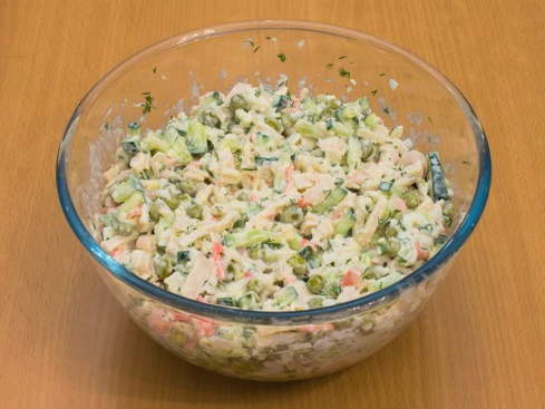 Salad with squid, egg, cucumber and green peas