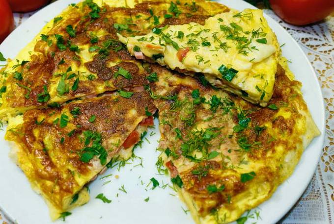 Lavash breakfast with sausage, tomato, cheese and egg in a pan