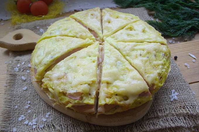 Lavash pizza with sausage, cheese and egg in a pan