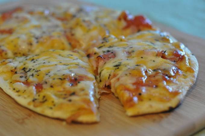 Lavash pizza with sausage and cheese in the oven