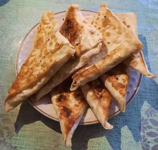 PP pita bread with egg and cheese in a frying pan