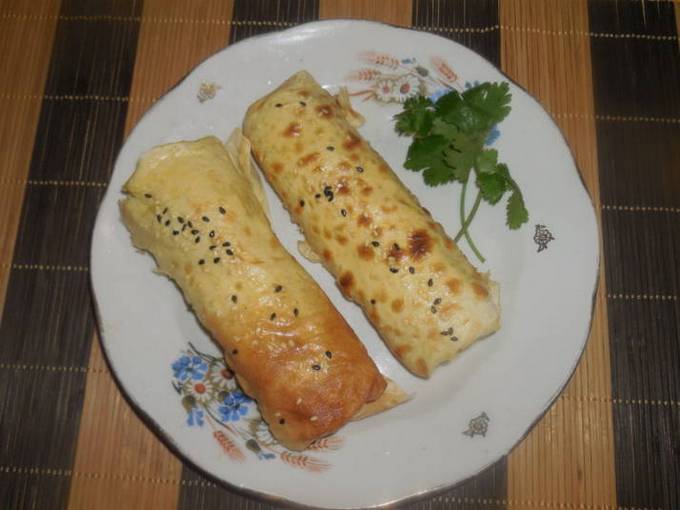 Sausage with potatoes in pita bread in a pan