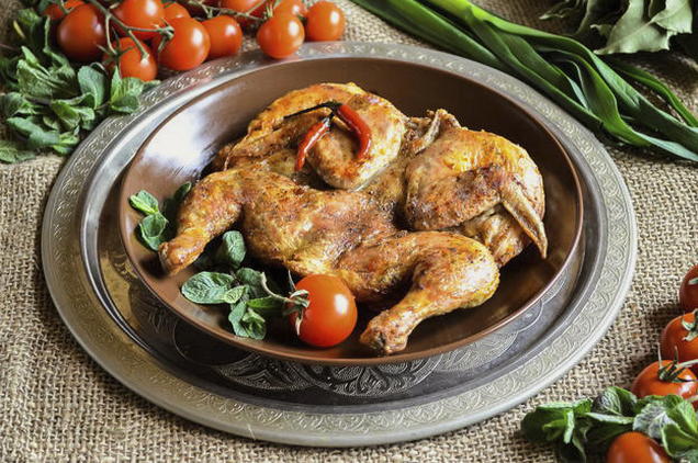 Chicken tobacco in a frying pan under pressure at home