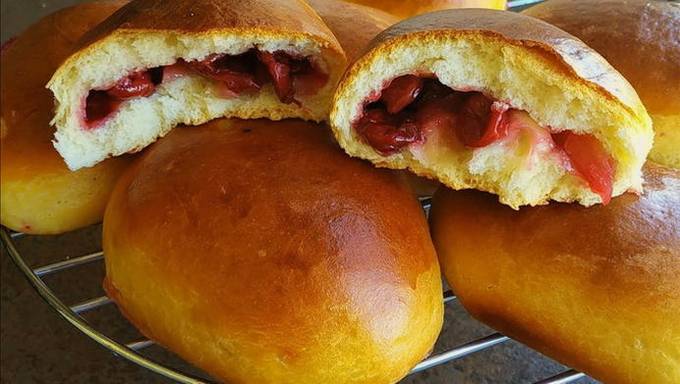 Dough for pies with cherries in a pan