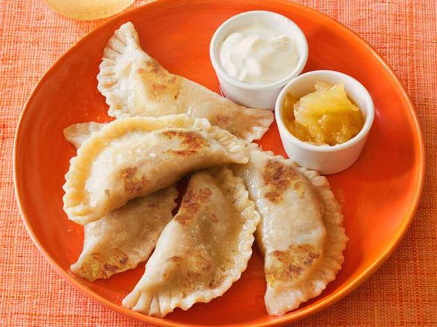 Frozen dumplings with potatoes fried in a pan