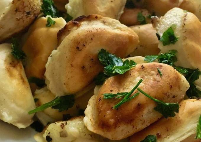 Fried dumplings with potatoes in a pan