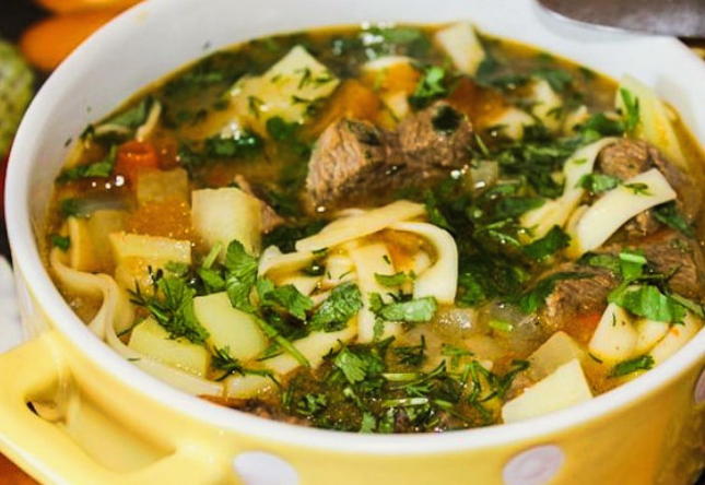 Lagman in a cauldron on a beef stove