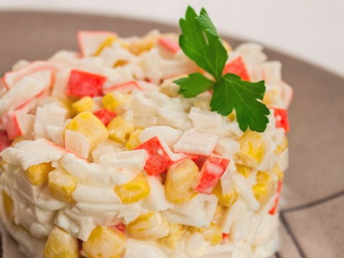 Salad with crab sticks, corn and onions