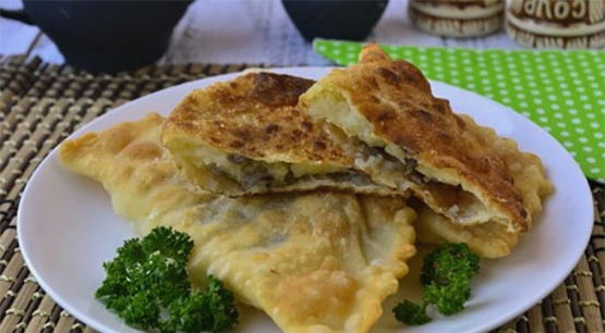 Chebureks with potatoes and mushrooms