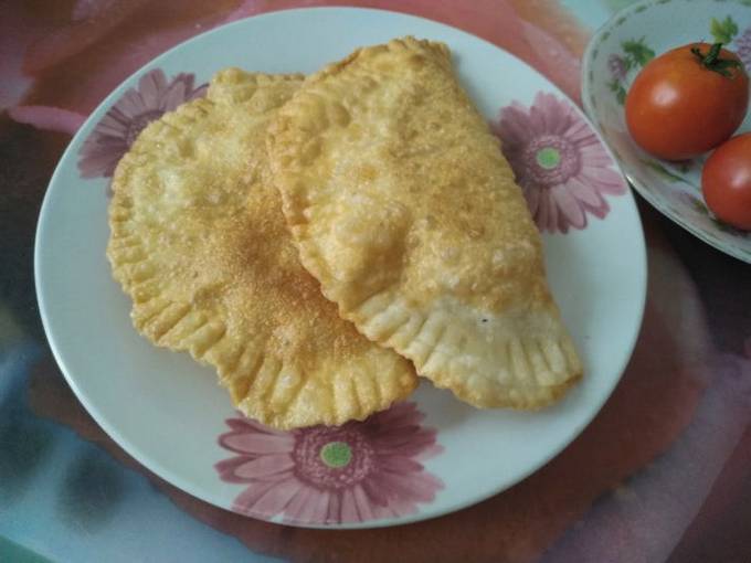 Homemade pasties with minced chicken in a pan