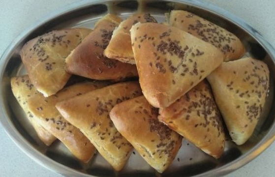 Samsa from yeast dough with chicken and potatoes in the oven