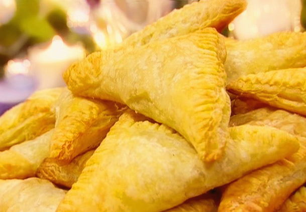 Puff pastry samsa with minced meat and onions in the oven