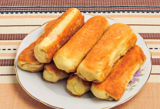 Sausages in a puff yeast-free dough in a pan