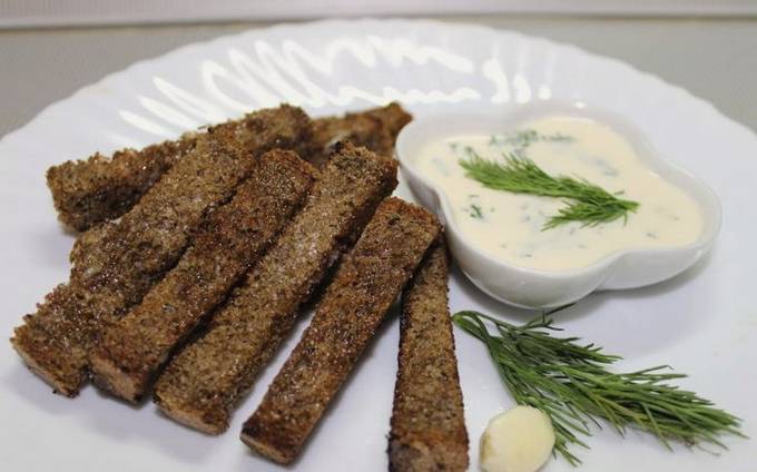 Garlic toasts for beer from black bread in a pan