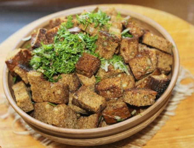 Rye croutons with garlic in a pan