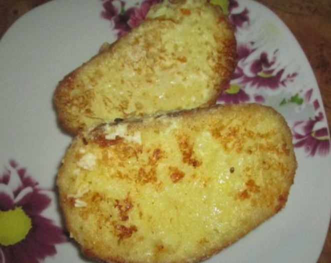 White bread croutons with egg and cheese in a pan