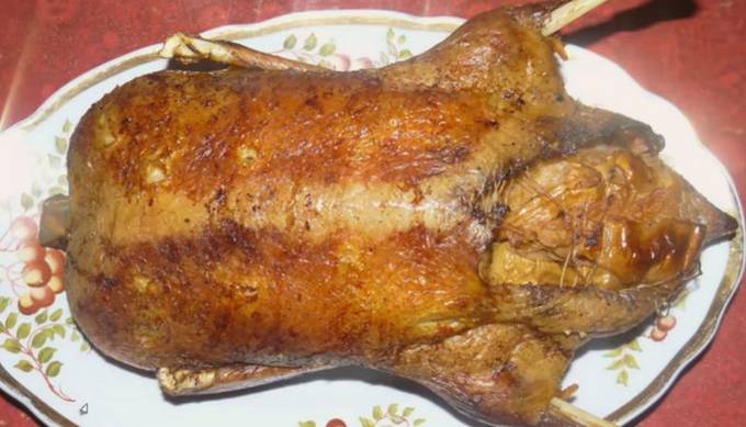 Duck with apples in a rooster in the oven