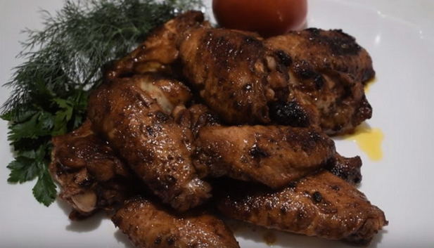 Wings in soy sauce with garlic in a pan