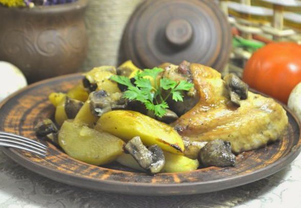 Wings with potatoes and mushrooms in the oven