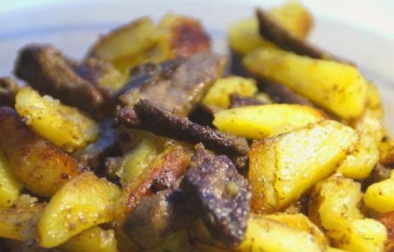 Chicken liver with onions and potatoes in a pan