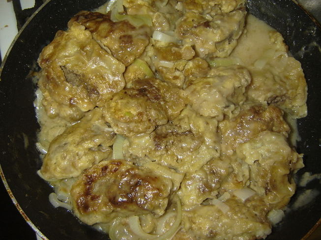 Chicken liver in milk with onions in a pan