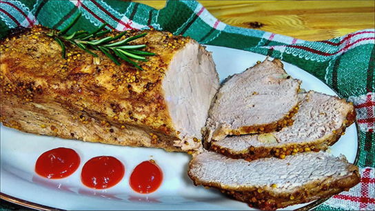 Whole piece of pork with honey and mustard in foil in the oven