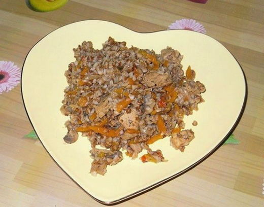 Pork pieces with onions and carrots in a pan