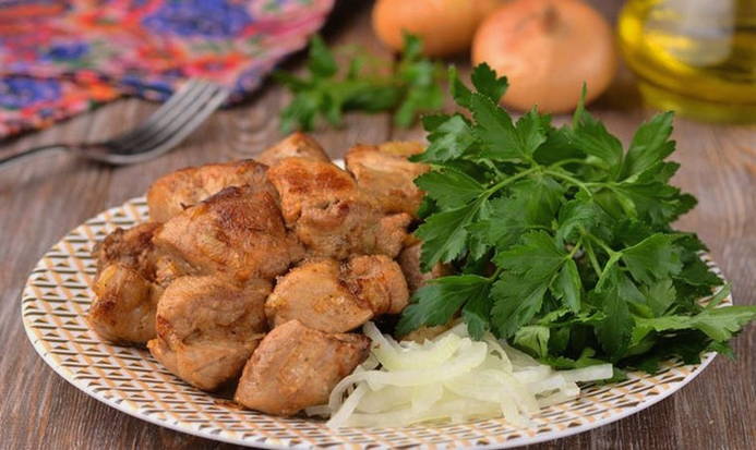 Pork pieces with onions in a pan