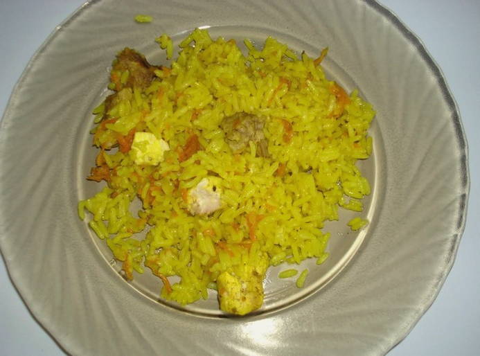 Pilaf with chicken breast in a saucepan on the stove