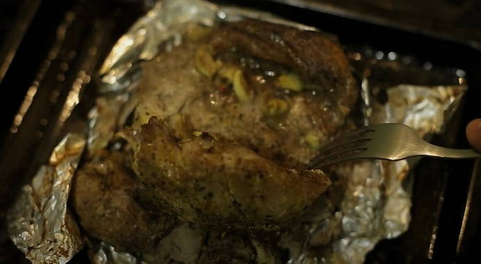 Whole piece of pork baked in foil in the oven