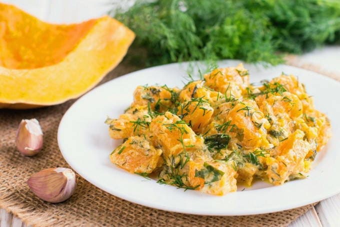 Pumpkin slices with garlic and cheese in the oven