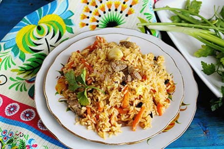 Loose lamb pilaf in a cauldron on the stove