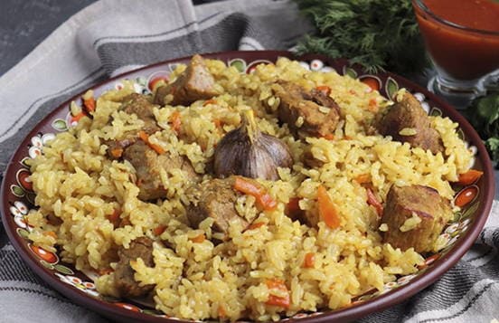 Correct pork pilaf in a cauldron