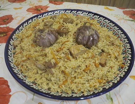 Pork pilaf in a cauldron on the fire