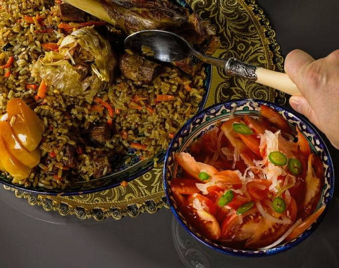 Uzbek lamb pilaf in a cauldron on the fire