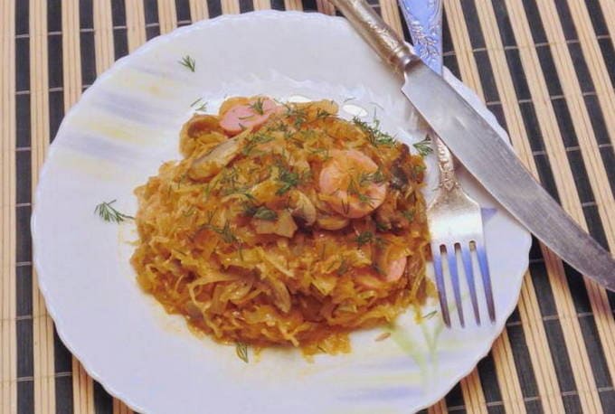 Classic sauerkraut hodgepodge with sausages in a pan